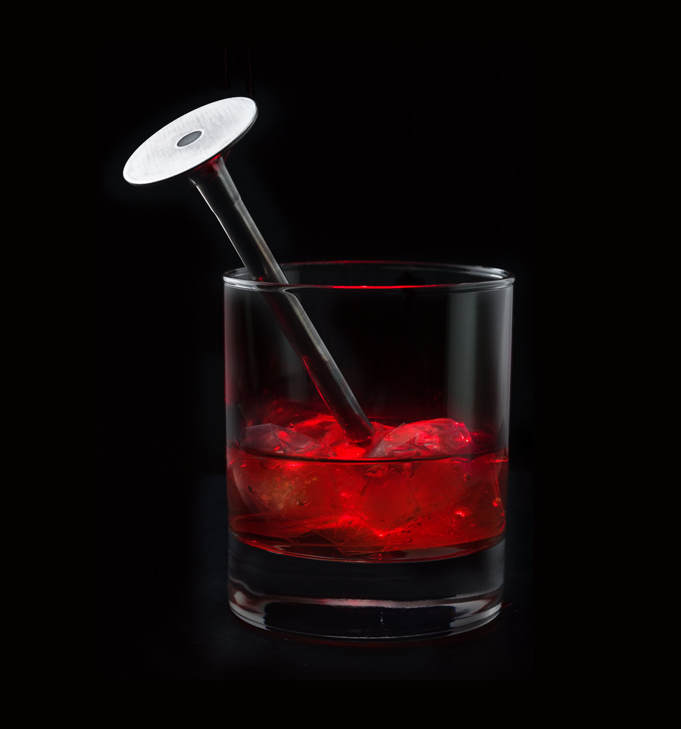 Engine valve in a glass with red fluid