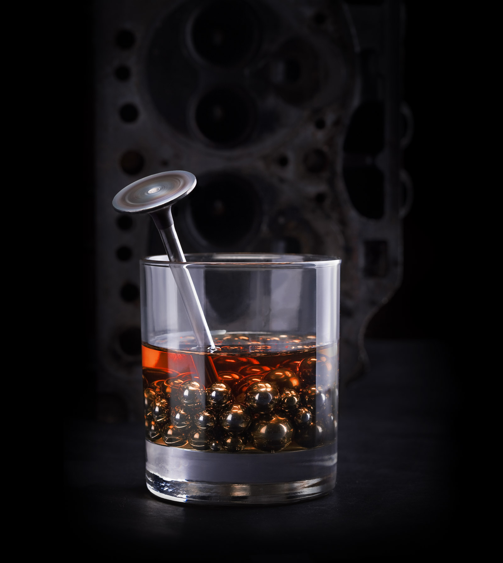 Amber lubricant alongside metal components and an engine valve